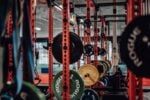 A well-equipped gym with various weightlifting gear and exercise equipment.